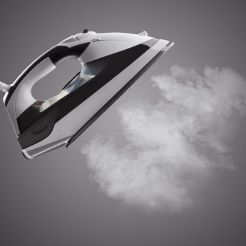 steam iron steam on dark gray background